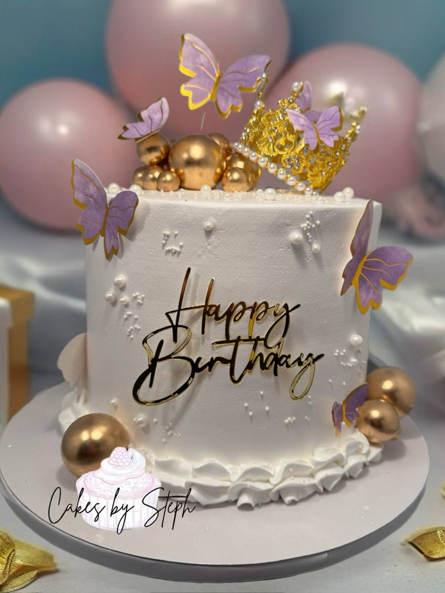 White cake with gold "Happy Birthday", crown and purple butterflies by Cakes by Steph, Leesburg VA