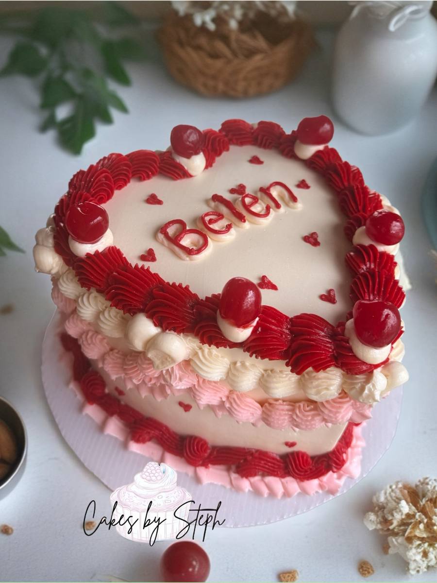 Pink heart cake with red piped borders, cherries and Belén name by Cakes by Steph, Leesburg VA