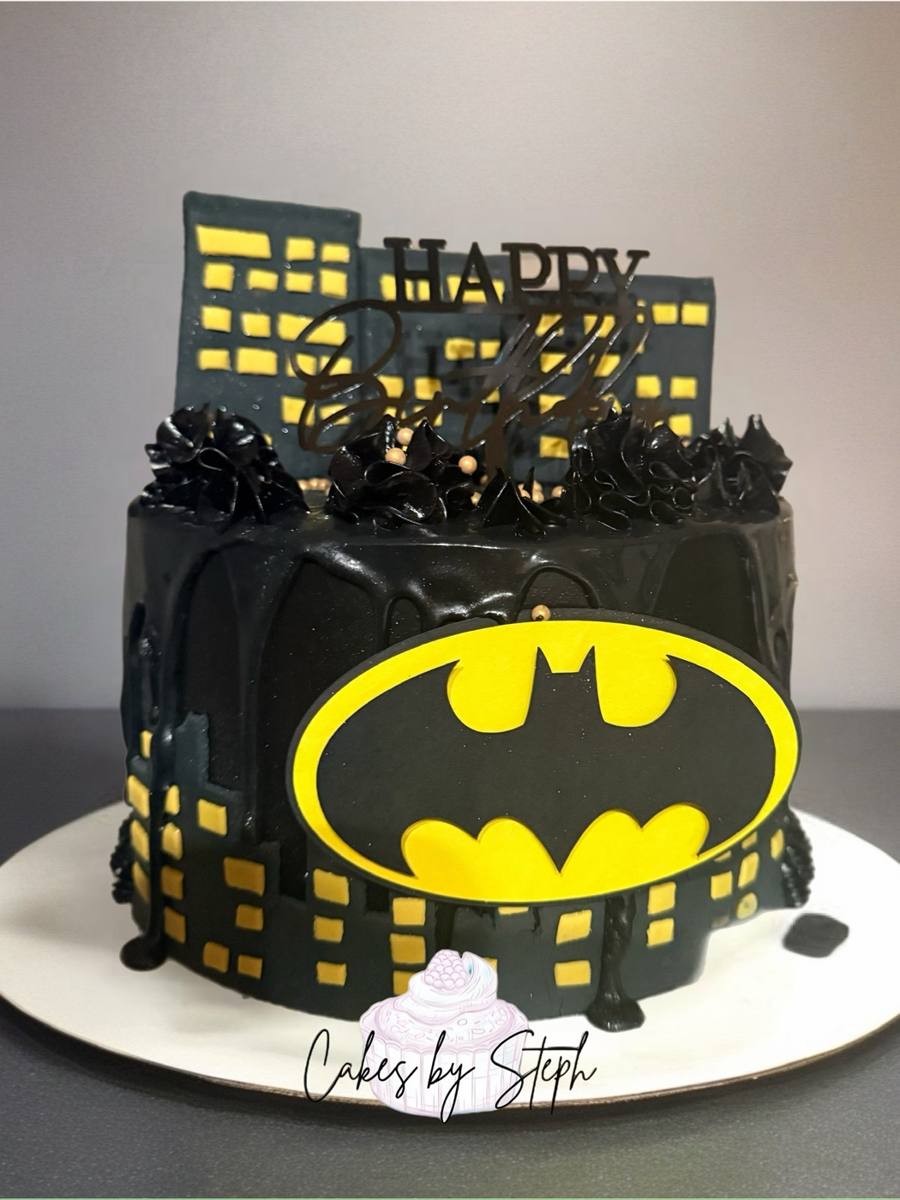 Black Batman cake with yellow logo, city skyline, "Happy Birthday" by Cakes by Steph, Leesburg VA