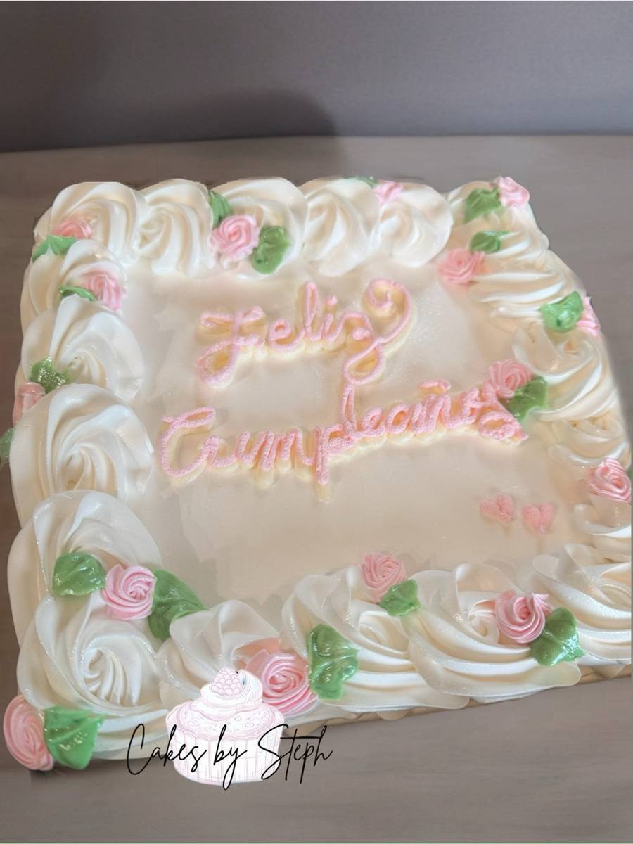 White square cake with pink "Feliz Cumpleaños", rosettes and roses by Cakes by Steph, Leesburg VA