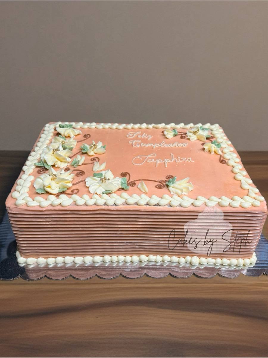 Peach square cake with "Feliz Cumpleaños Sapphira" and cream flowers by Cakes by Steph, Leesburg VA