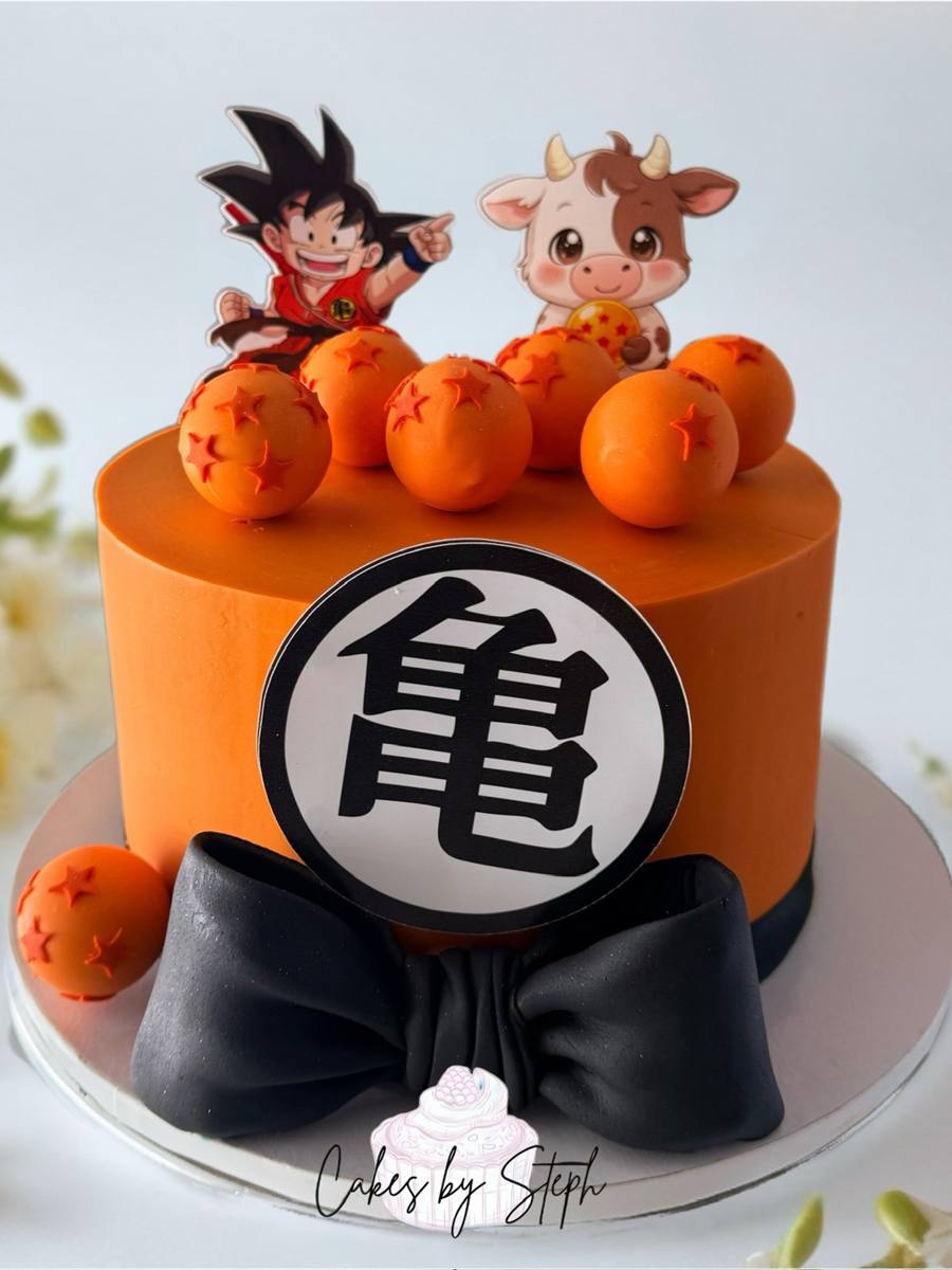 Orange Dragon Ball Z cake, Goku topper, dragon balls, black bow by Cakes by Steph, Leesburg VA
