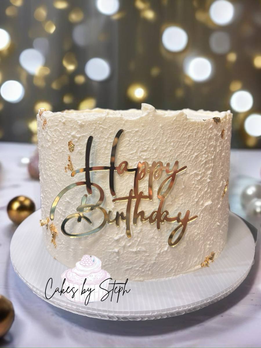 White textured cake with gold leaf, gold "Happy Birthday" script by Cakes by Steph, Leesburg VA