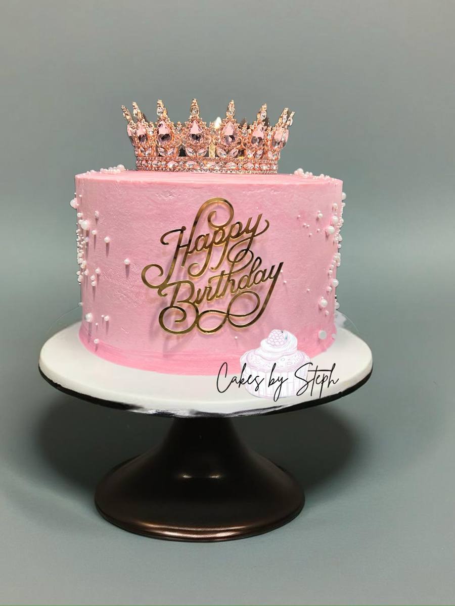 Pink cake with jeweled crown topper and "Happy Birthday" text by Cakes by Steph, Leesburg VA