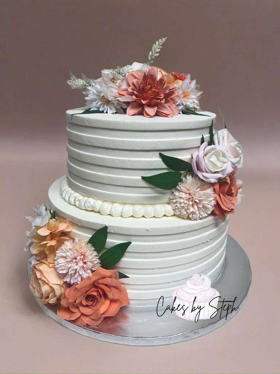 Two-tier white cake with peach and cream florals by Cakes by Steph, Leesburg VA