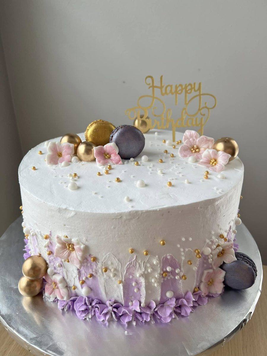 White birthday cake with purple and gold macarons and sugar flowers by Cakes by Steph, Leesburg VA