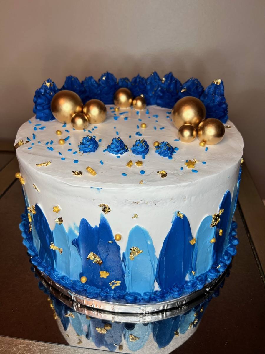White cake with blue brushstrokes, gold spheres, blue sprinkles by Cakes by Steph, Leesburg VA
