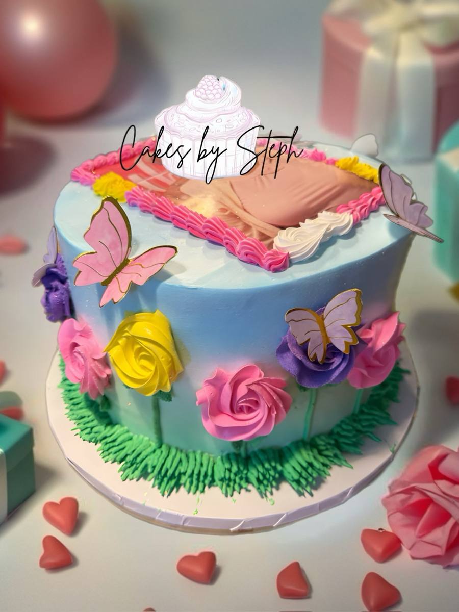 Blue cake with paper butterflies, colorful buttercream roses and grass by Cakes by Steph, Leesburg VA