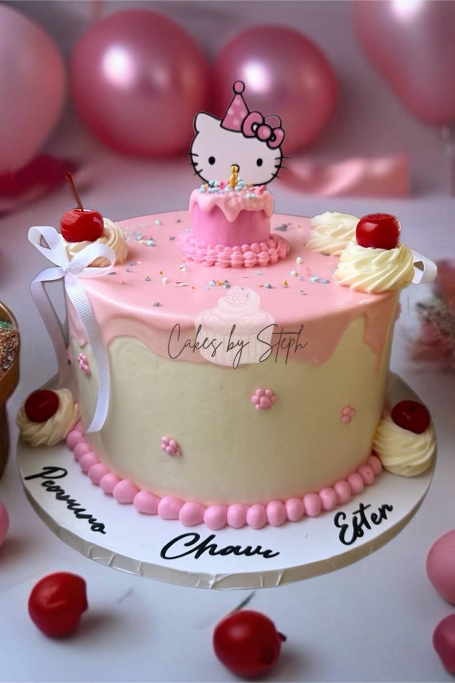 Pink and cream Hello Kitty cake with cherries and names by Cakes by Steph, Leesburg VA