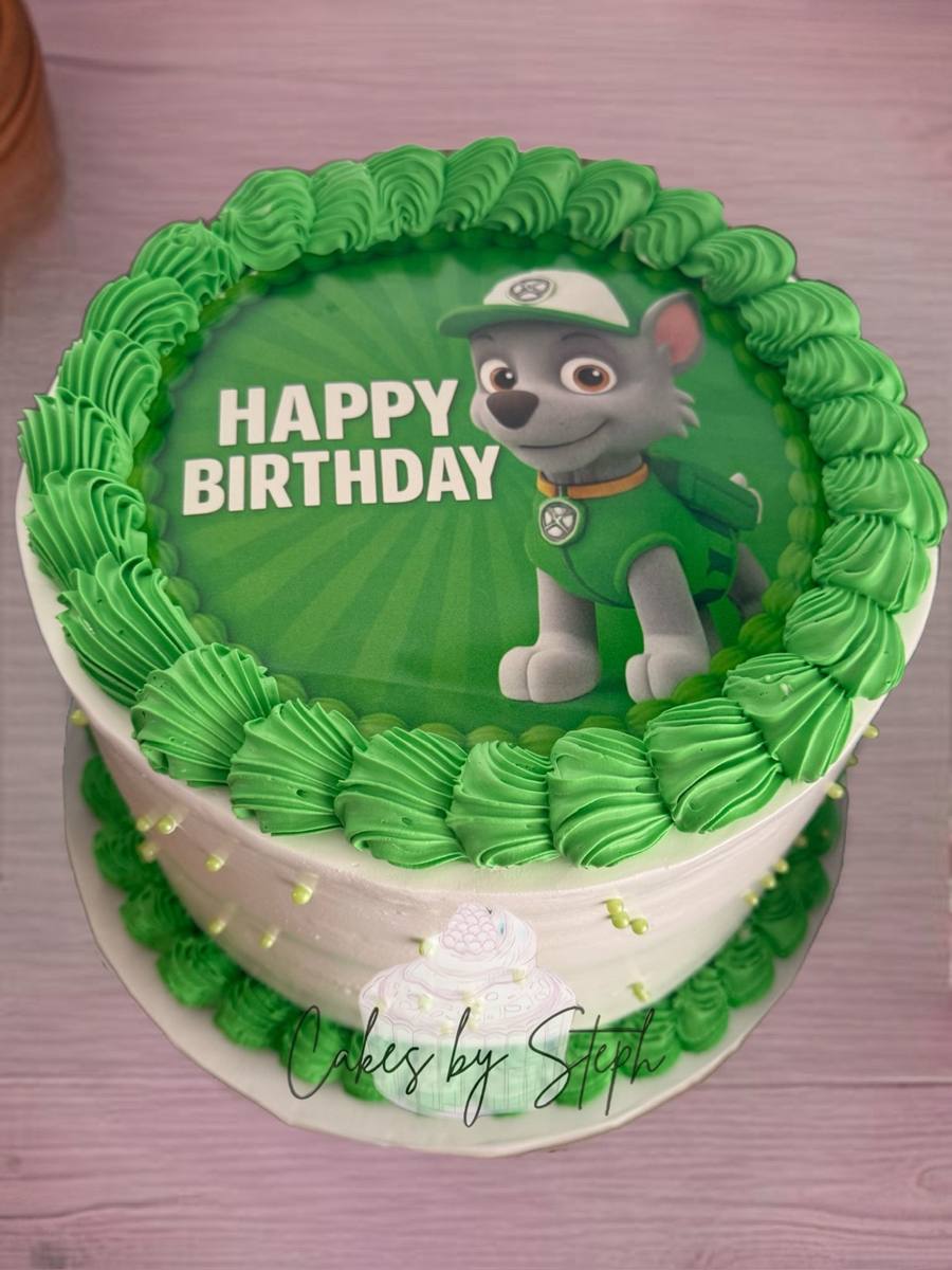 Green cake with Paw Patrol Rocky image and "Happy Birthday" by Cakes by Steph, Leesburg VA