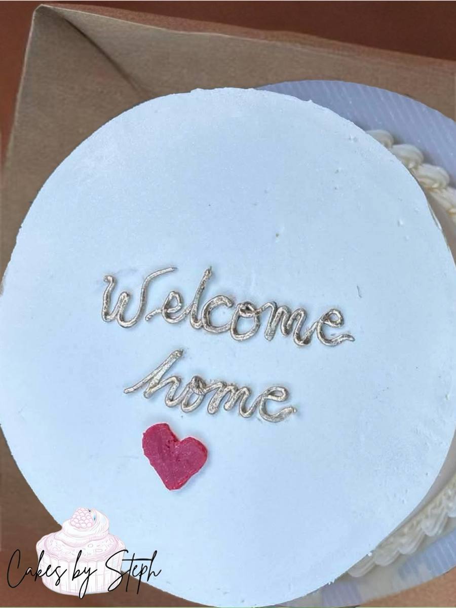 White cake with gold Welcome home script and red heart by Cakes by Steph, Leesburg VA