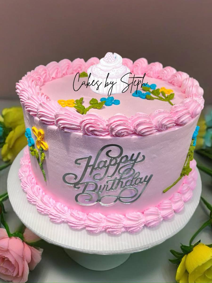 Pink buttercream cake with piped flowers and silver Happy Birthday topper by Cakes by Steph, Leesburg VA
