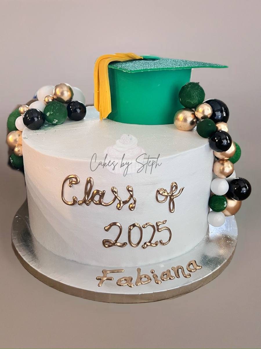 White cake with green graduation cap, gold balls, "Class of 2025 Fabiana" by Cakes by Steph, Leesburg VA