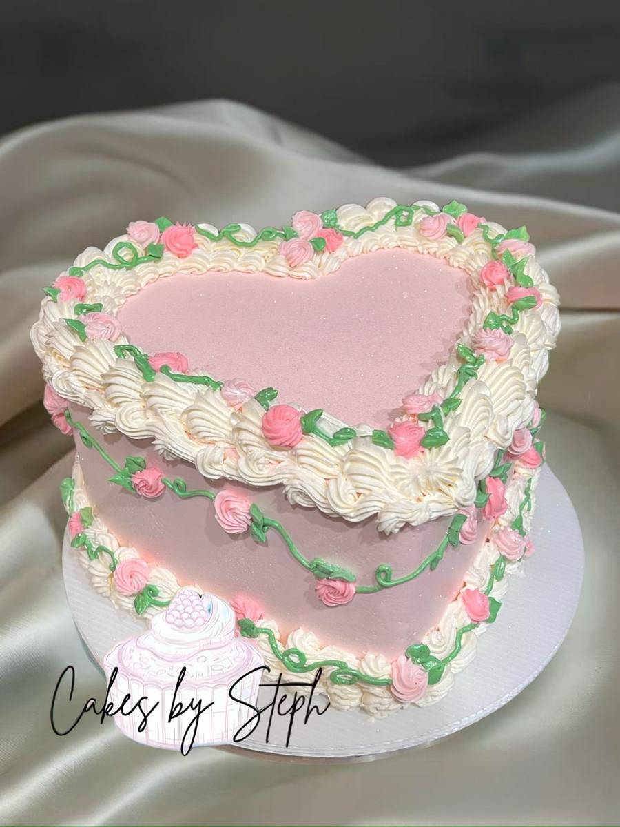 Two-tier pink heart cake, white piping, pink roses, green vines by Cakes by Steph, Leesburg VA